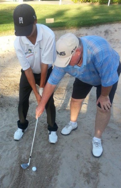 In the bunker, focus on the spot behind the ball, as demonstrated by Jae