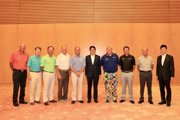 From left, Tom Lehman, Tom Watson, Scott McCarron, Jay Haas, Olin Brown, Japan Prime Minister Shinzo Abe, John Daly, Billy Andrade, Larry Nelson and Deputy Chief Cabinet Secretary Yasutoshi Nishimura.