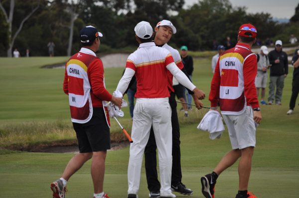 Team China perform one of their many "Chest bumps" throughout the round