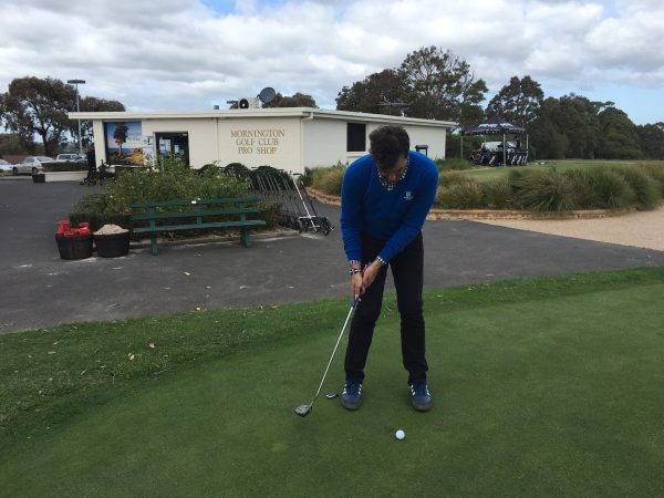 A typical putting stroke: the head is still, while the arms control the stroke.