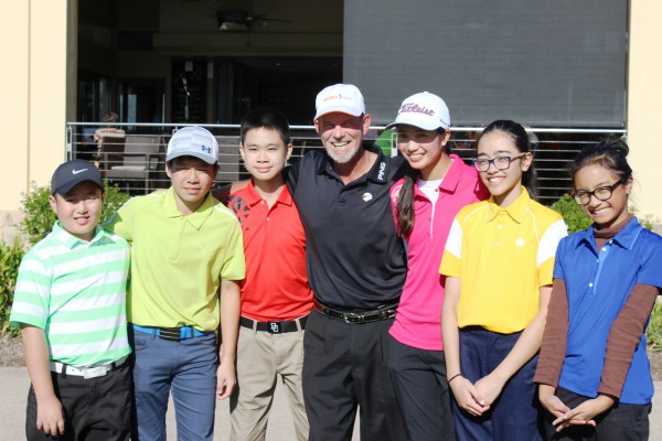 Teaching pro Tony Blacker poses with a group of his young golfing students.